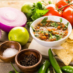 Bowl of salsa and fresh ingredients for preparation